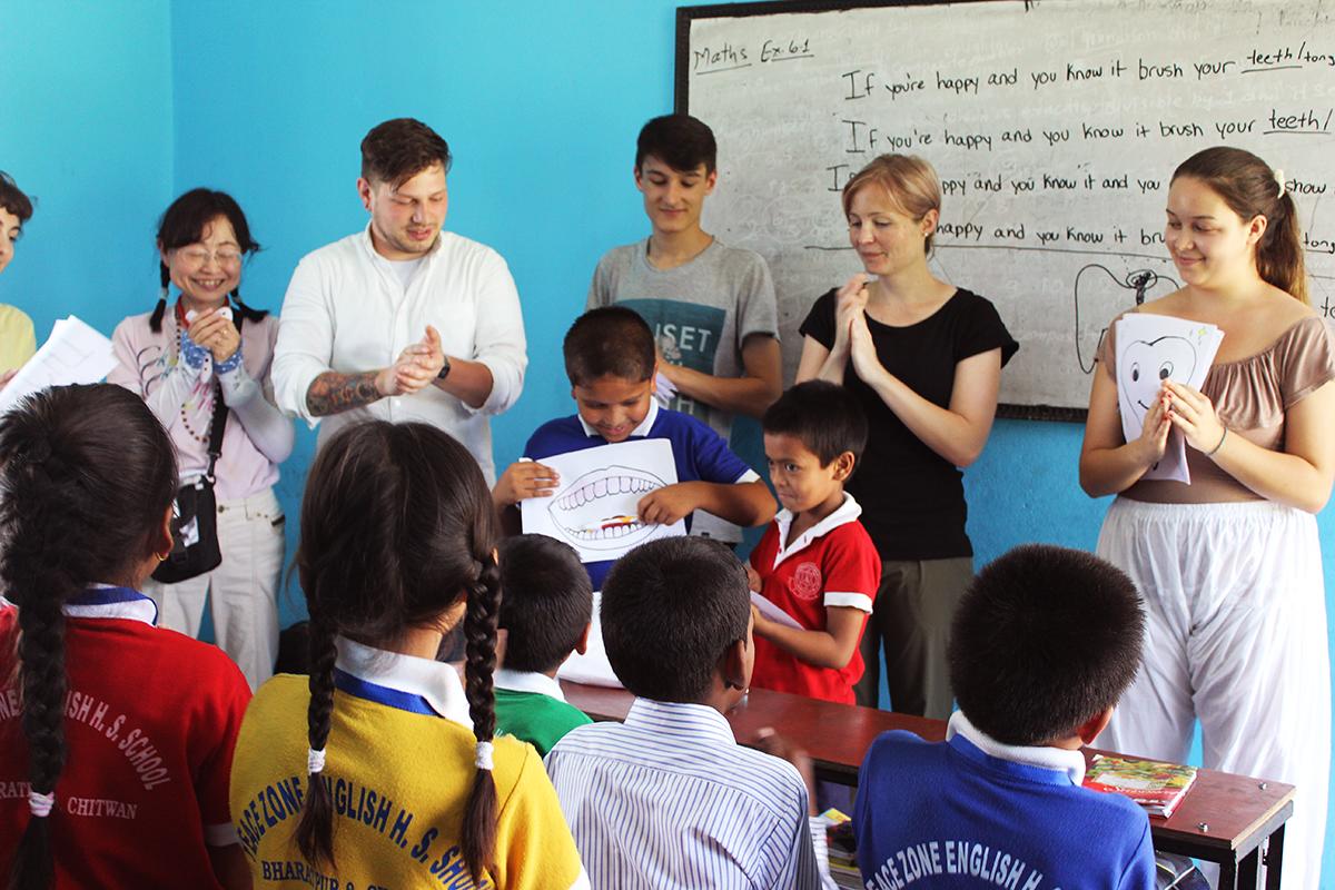 A young boy practises his English while presenting to the class at our teaching placement in Nepal Projects Abroad volunteers teaching in Nepal encourage a student to present to the class in English during a dental hygiene lesson